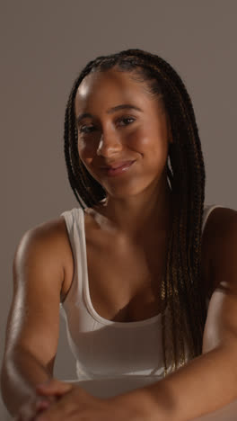 Studio-Beauty-Shot-Of-Young-Woman-With-Long-Braided-Hair-Sitting-At-Table-1